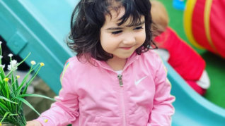 Smiling girl in a pink dress
