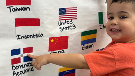 Boy pointing at a flag