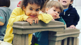 Smiling boy with kids in the background