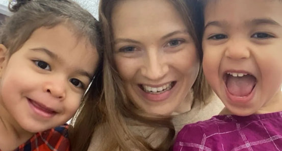 Two kids and a teacher smiling