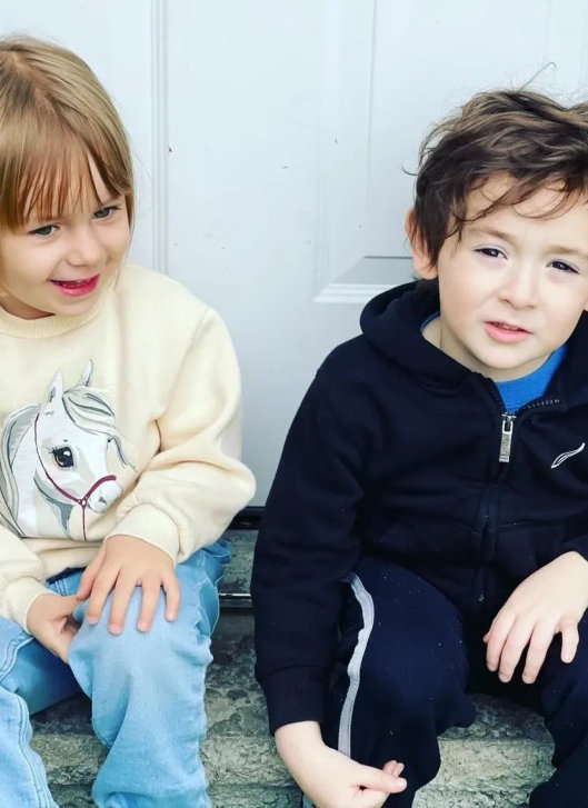 Two boys posing and smiling at the camera