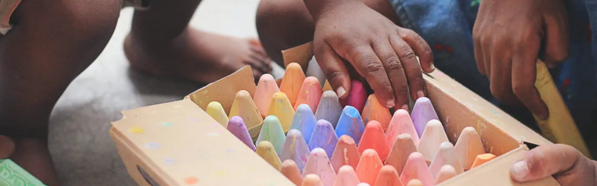 Kid picking colored materials from a box