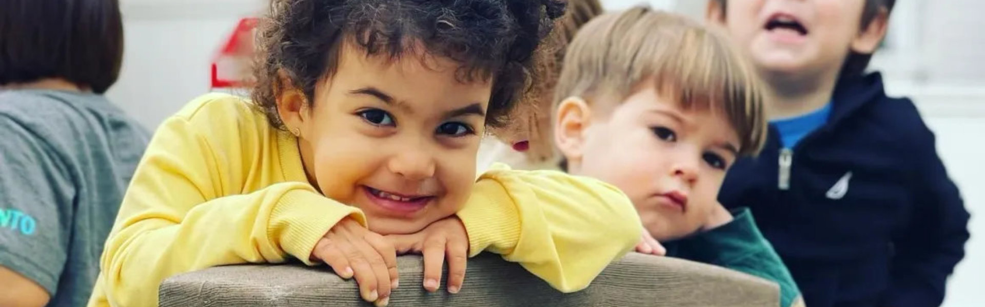 Smiling boy with other kids in the background