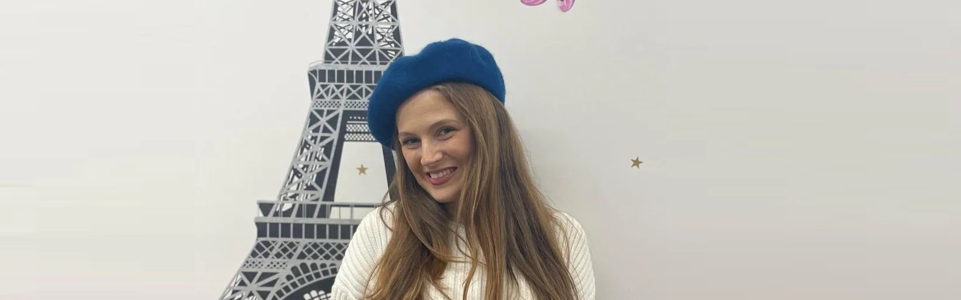 Smiling woman posing in front of a tower drawing
